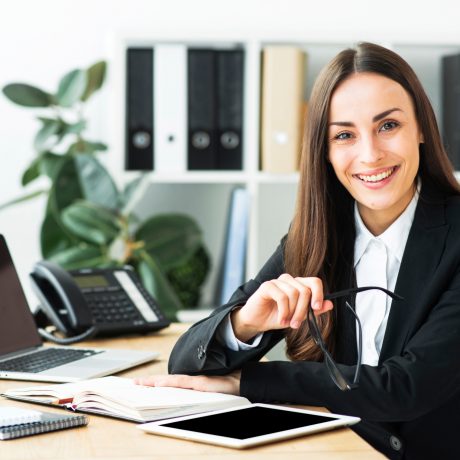 Woman in smart work attire smiling at camera